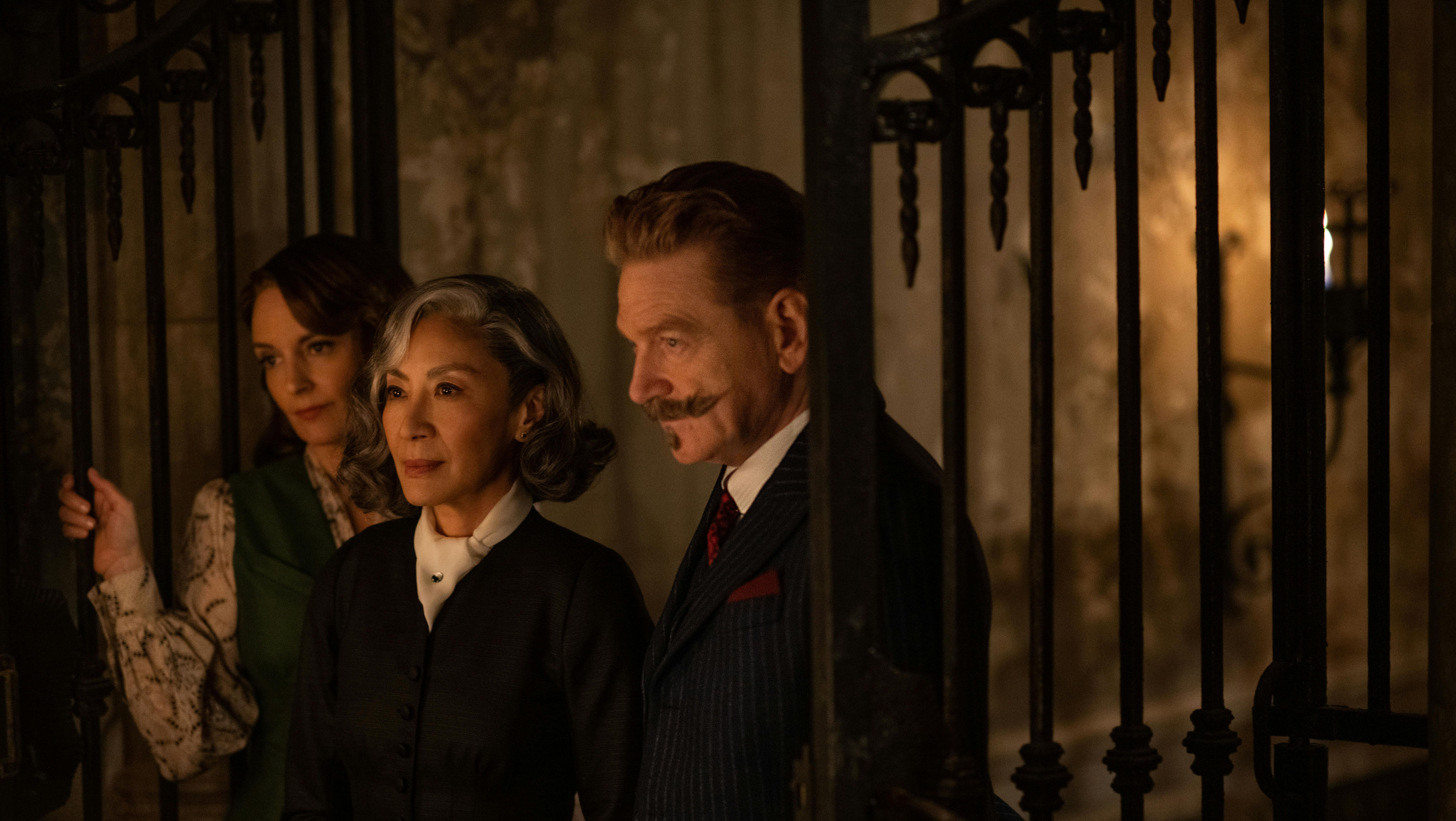 (L-R): Tina Fey as Ariadne Oliver, Michelle Yeoh as Mrs. Reynolds, and Kenneth Branagh as Hercule Poirot in 20th Century Studios' A HAUNTING IN VENICE. Photo by Rob Youngson. © 2023 20th Century Studios. All Rights Reserved.