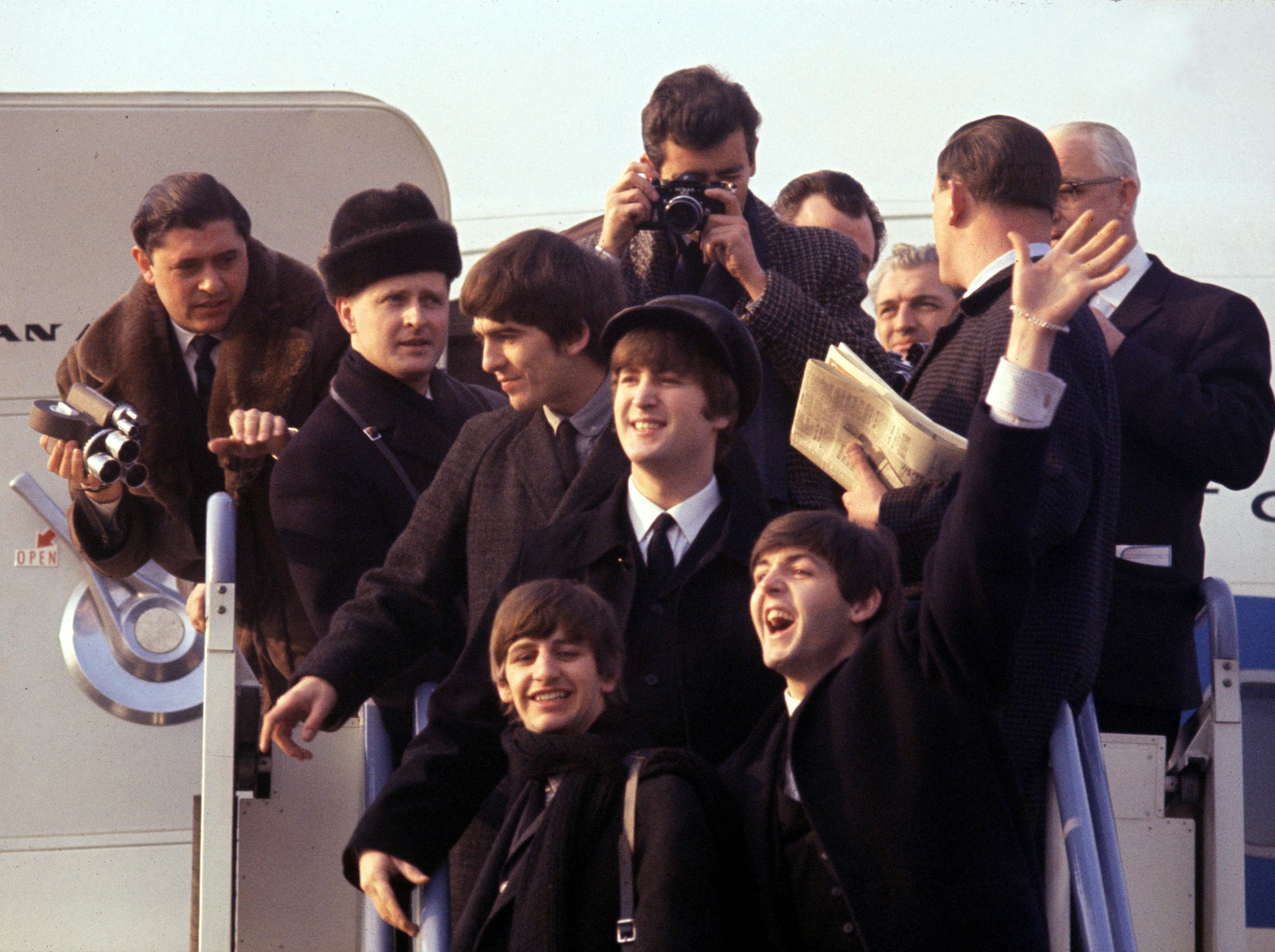 (L-R) George Harrison, Ringo Starr, John Lenon, and Paul Mccartney arriving at JFK airport in BEATLES 64'. Photo Courtesy of Apple Corps, Ltd. All Rights Reserved.
