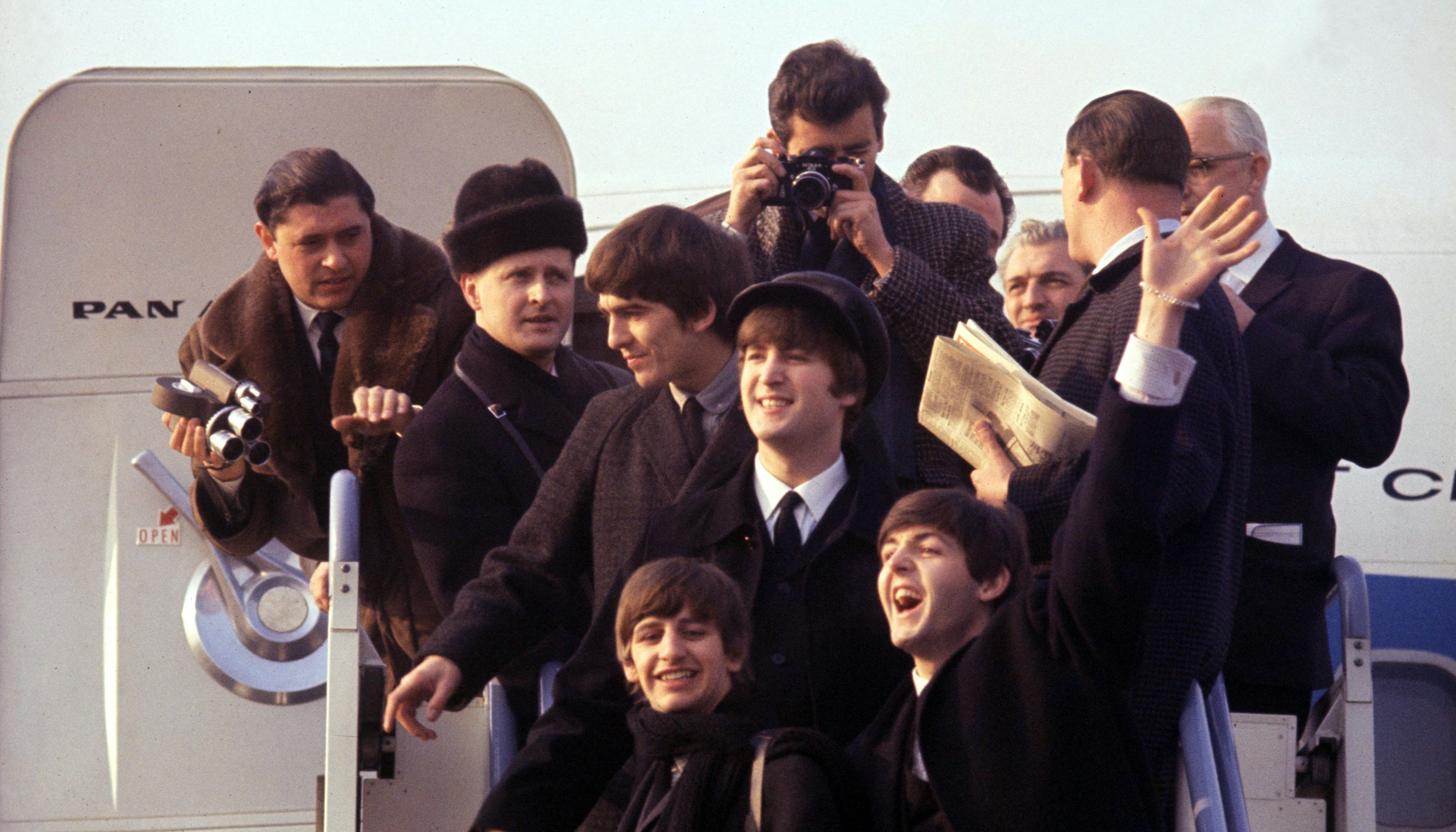 (L-R) George Harrison, Ringo Starr, John Lenon, and Paul Mccartney arriving at JFK airport in BEATLES 64'. Photo Courtesy of Apple Corps, Ltd. All Rights Reserved.