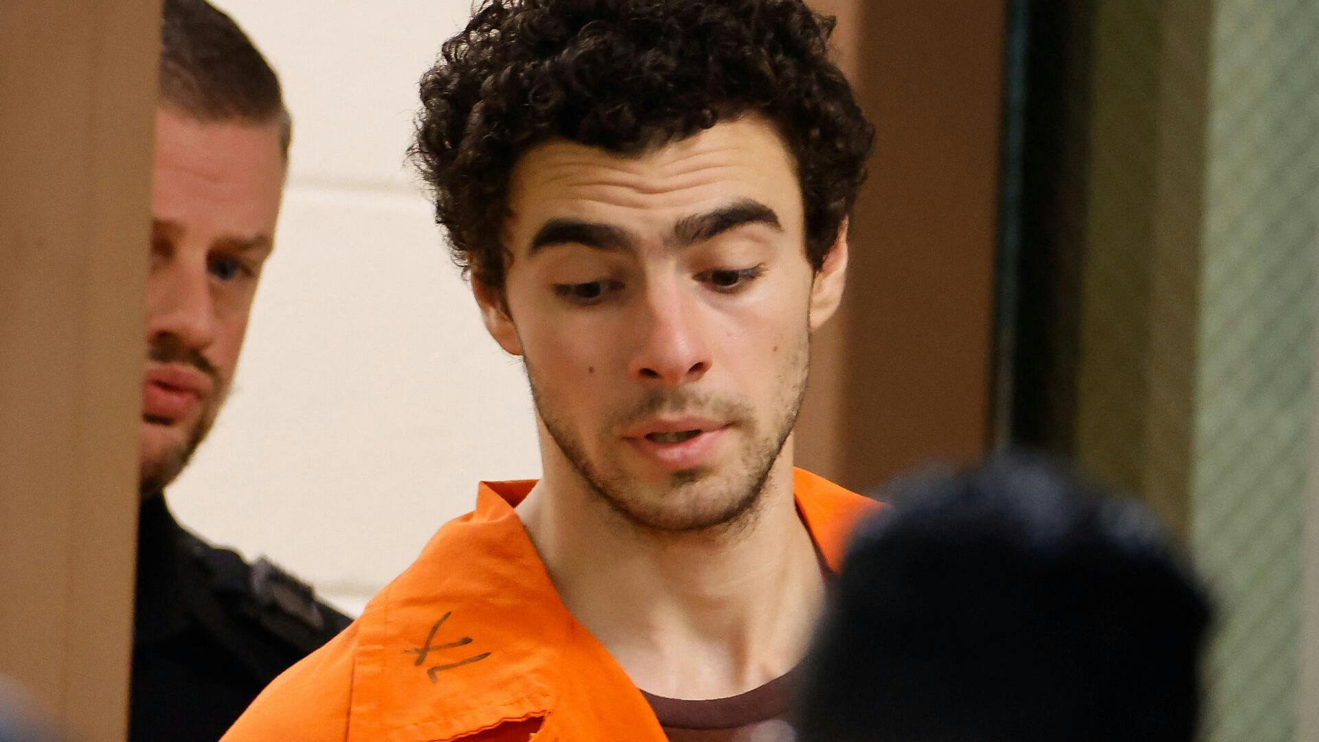 Luigi Mangione, 26, a suspect in the New York City killing of UnitedHealth executive Brian Thompson, is escorted after an extradition hearing at Blair County Court House in Hollidaysburg, Pennsylvania, U.S. December 10, 2024. REUTERS/Eduardo Munoz