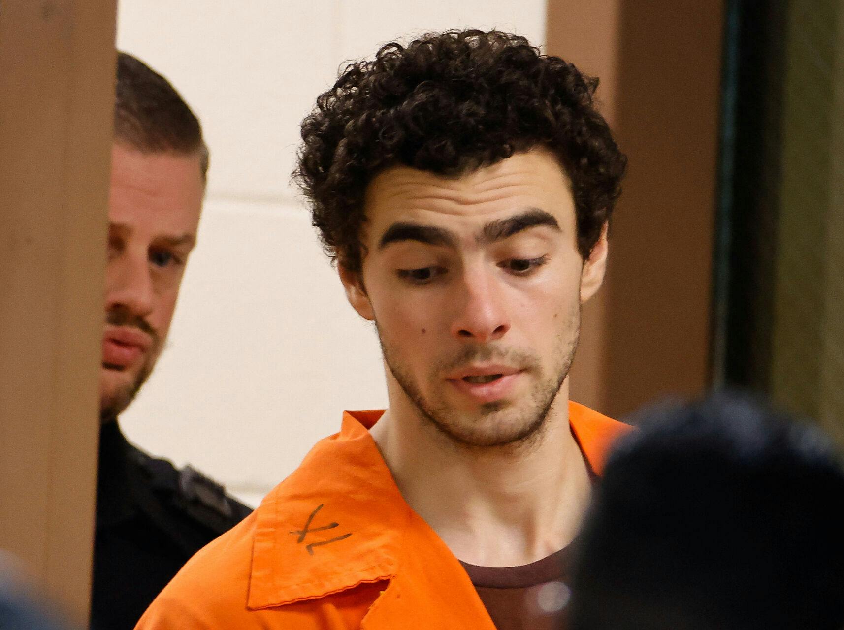 Luigi Mangione, 26, a suspect in the New York City killing of UnitedHealth executive Brian Thompson, is escorted after an extradition hearing at Blair County Court House in Hollidaysburg, Pennsylvania, U.S. December 10, 2024. REUTERS/Eduardo Munoz