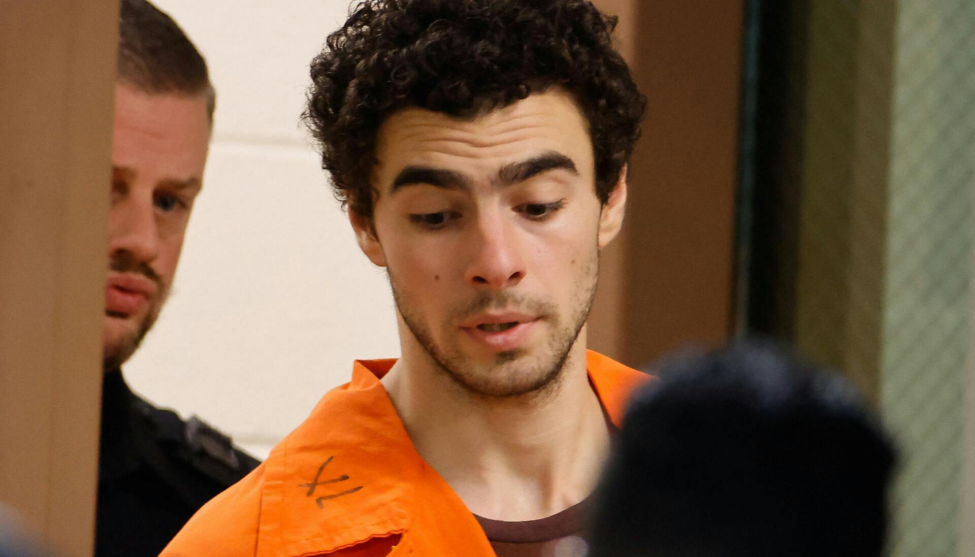 Luigi Mangione, 26, a suspect in the New York City killing of UnitedHealth executive Brian Thompson, is escorted after an extradition hearing at Blair County Court House in Hollidaysburg, Pennsylvania, U.S. December 10, 2024. REUTERS/Eduardo Munoz