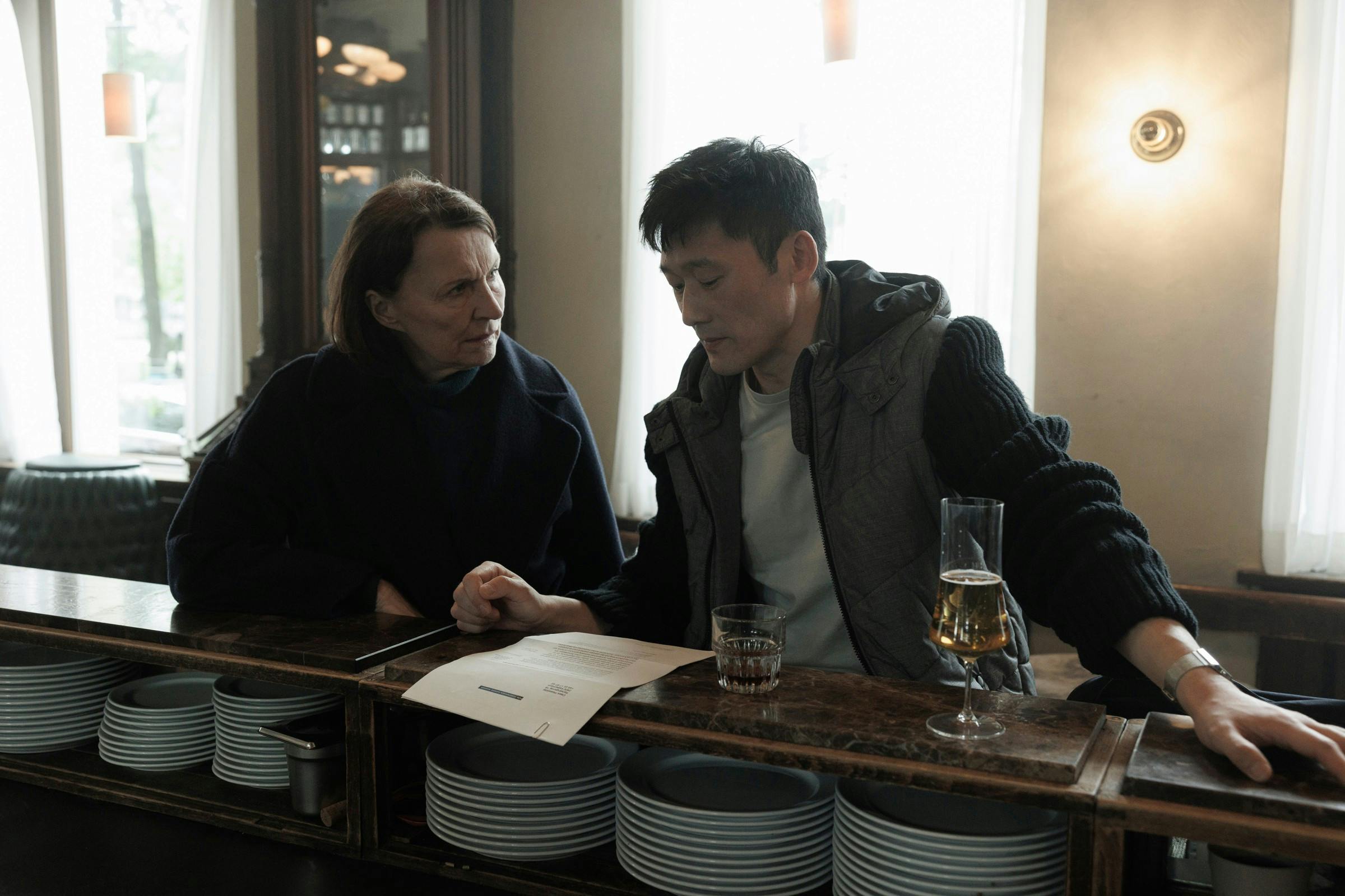 Actors: Karen-Lise Mynster & Thomas Hwan Roles: Inger Brøgger & Jesper LiholtScene Description: Brøgger is dismayed, Liholt asks what they should do.Producers: Michael Polle & Mariella Santibáñez, Ole Søndberg & Rikke Lassen & Louise Kruse