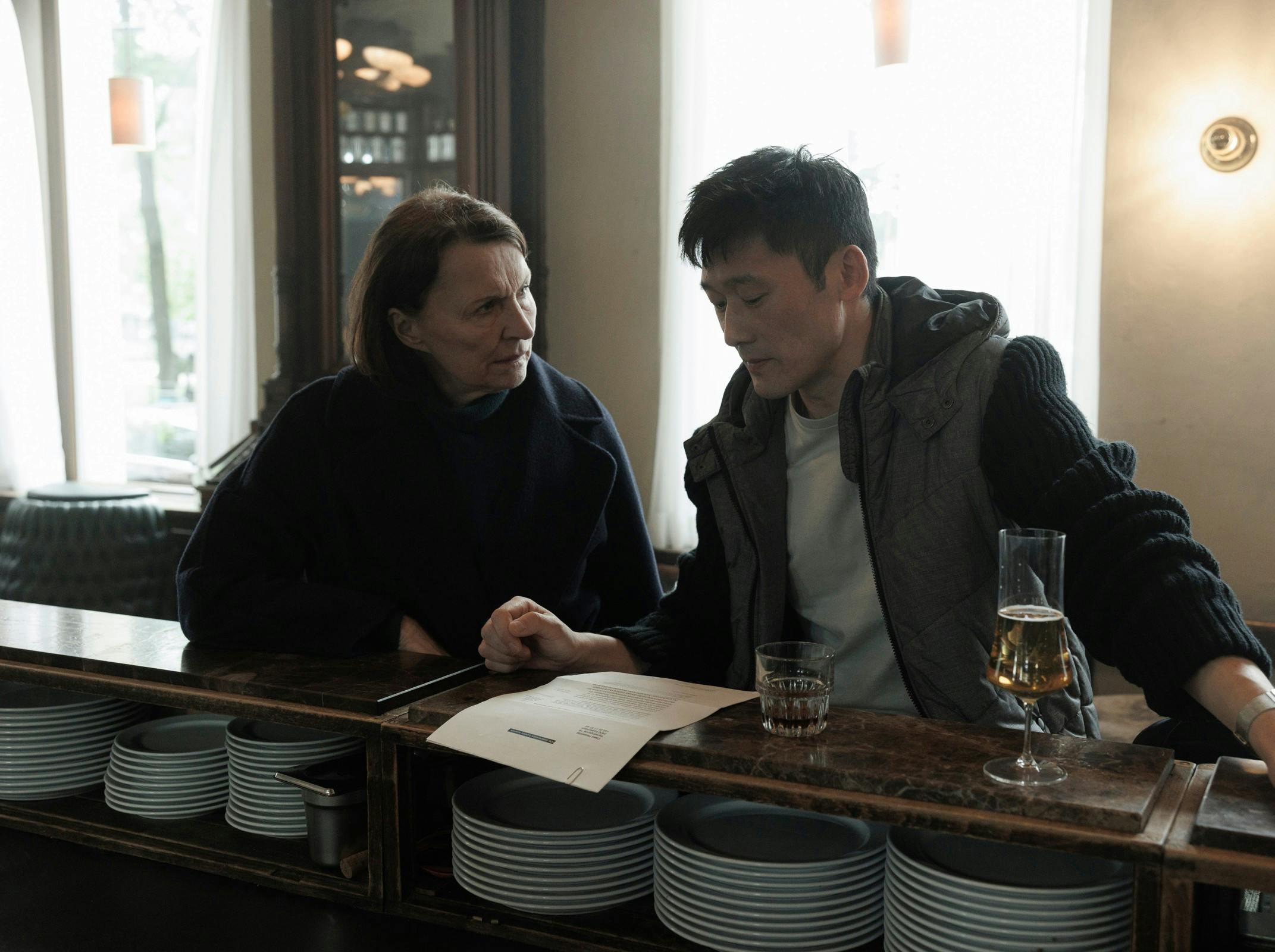 Actors: Karen-Lise Mynster & Thomas Hwan Roles: Inger Brøgger & Jesper LiholtScene Description: Brøgger is dismayed, Liholt asks what they should do.Producers: Michael Polle & Mariella Santibáñez, Ole Søndberg & Rikke Lassen & Louise Kruse