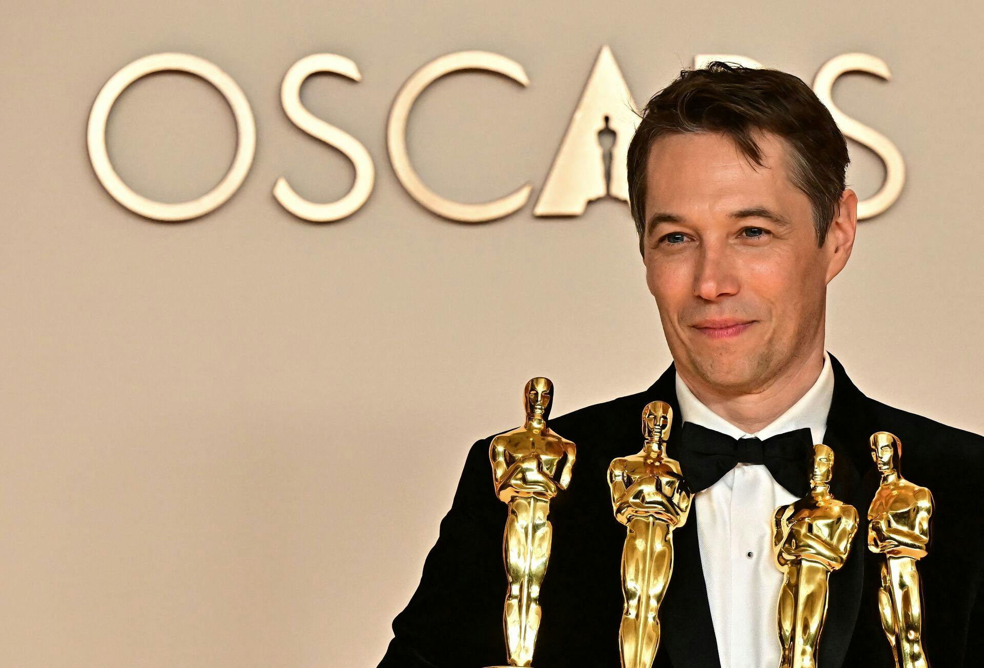 US producer Sean Baker poses in the press room with the Oscars for Best Film Editing, Best Original Screenplay, Best Director and Best Picture for "Anora" during the 97th Annual Academy Awards at the Dolby Theatre in Hollywood, California on March 2, 2025. (Photo by Frederic J. Brown / AFP)